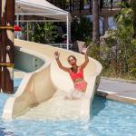teen girl sliding down pool slide