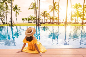 young woman sitting by pool