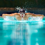 Perfect butterfly stroke. a male swimmer doing the butterfly stroke toward the camera