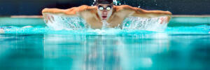 Perfect butterfly stroke. a male swimmer doing the butterfly stroke toward the camera