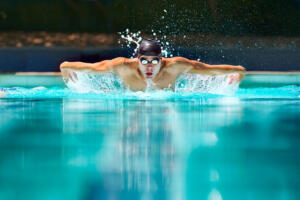 Perfect butterfly stroke. a male swimmer doing the butterfly stroke toward the camera