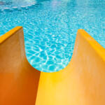 Step with slide in the pool by the sea nature background. For bathing turquoise water.