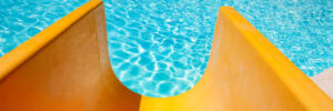 Step with slide in the pool by the sea nature background. For bathing turquoise water.