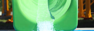 Green slide in water park. Summer vacation