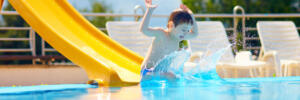 cute boy kid having fun on water slide