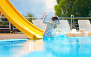 cute boy kid having fun on water slide