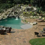 Backyard pool watersldie with landscape design