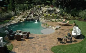 Backyard pool watersldie with landscape design