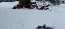 pool and pool slide covered in snow during the winter