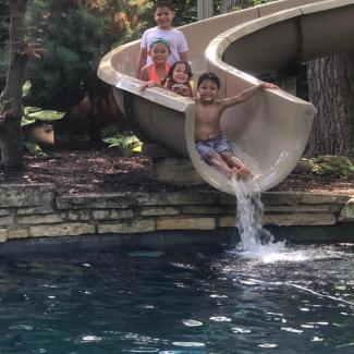Kids going down water slide